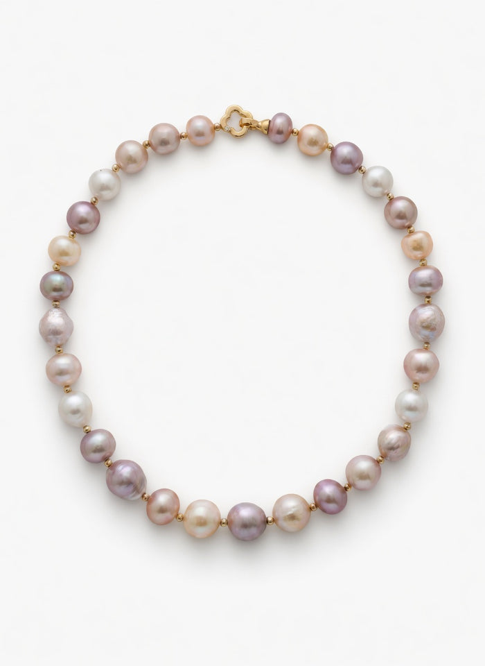 Pearl necklace with gold clasp on a white background