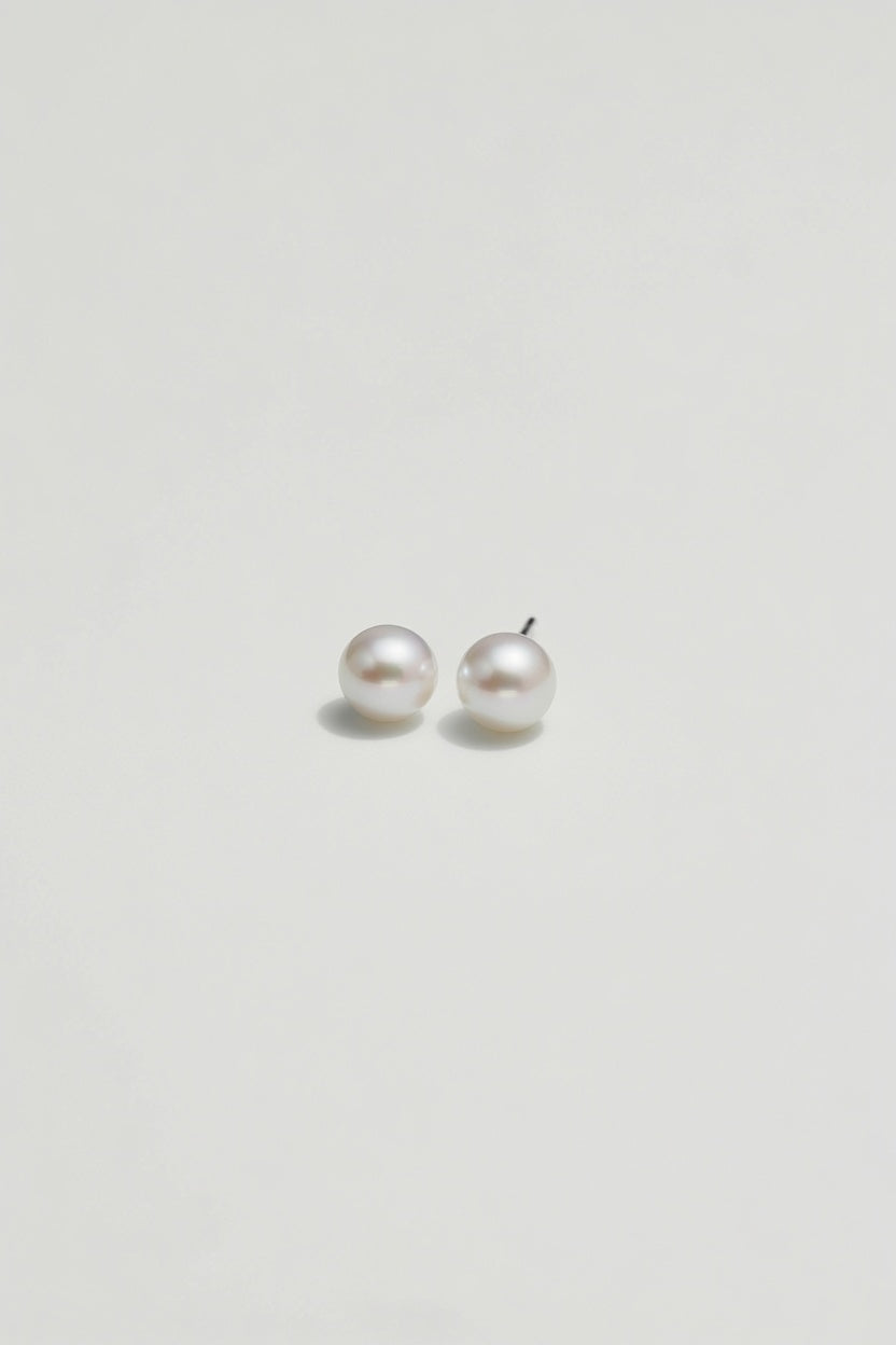 Pair of pearl earrings on a light gray background