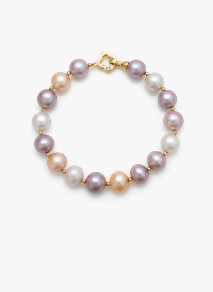 Pearl bracelet with gold clasp on a white background
