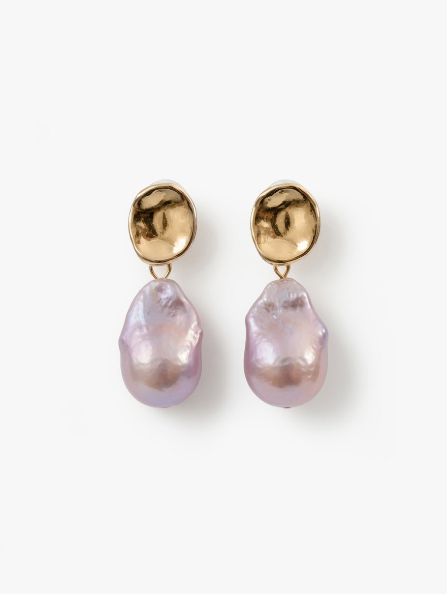 Pair of earrings with gold tops and pinkish-purple drops on a white background